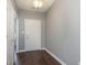 Bright entryway with dark hardwood floors and neutral-colored walls at 5437 Basin Park Dr, Indianapolis, IN 46239