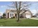 Ranch home with a large tree in the front yard and a two-car garage at 5437 Basin Park Dr, Indianapolis, IN 46239