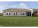 Tan house exterior with large backyard and screened porch at 5437 Basin Park Dr, Indianapolis, IN 46239