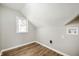 Small finished attic room with a single window and wood-look flooring at 550 Trowbridge St, Indianapolis, IN 46203