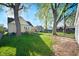 Large backyard with mature trees and a small deck off the back of the house at 550 Trowbridge St, Indianapolis, IN 46203