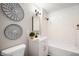 Bathroom featuring a combination tub and shower with a single vanity and decorative mirrors at 550 Trowbridge St, Indianapolis, IN 46203
