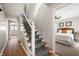Inviting entryway with carpeted stairs, wood floors, and access to bedroom and kitchen at 550 Trowbridge St, Indianapolis, IN 46203