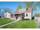 View of a charming home featuring a covered porch, well-maintained lawn, and inviting curb appeal at 550 Trowbridge St, Indianapolis, IN 46203