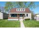 Charming home featuring a covered porch, well-maintained lawn, and inviting curb appeal at 550 Trowbridge St, Indianapolis, IN 46203