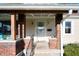 Inviting front porch with brick accents, a white door with wreath, and a well-maintained entrance at 550 Trowbridge St, Indianapolis, IN 46203