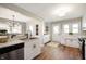 Well-lit kitchen with white cabinets, stainless steel appliances, and a stylish eat-in bar area at 550 Trowbridge St, Indianapolis, IN 46203