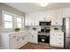 Modern kitchen with white cabinets, stainless steel appliances, and ample counter space at 550 Trowbridge St, Indianapolis, IN 46203