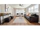Bright living room featuring hardwood floors, neutral paint, a ceiling fan, and ample seating at 550 Trowbridge St, Indianapolis, IN 46203