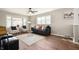 Bright living room featuring hardwood floors, neutral paint, a ceiling fan, and ample seating at 550 Trowbridge St, Indianapolis, IN 46203
