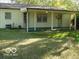 Spacious backyard featuring a covered patio with multiple access points and ample green space at 6508 Meadowlark Dr, Indianapolis, IN 46226