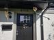 Inviting front door with window, decorated with a welcome sign and whimsical windchimes at 6508 Meadowlark Dr, Indianapolis, IN 46226