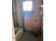 Dated bathroom needing renovation. Features a vintage tub and window at , Indianapolis, IN 46202