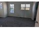 Spacious bedroom with neutral walls, carpet flooring, and two large windows at 7841 Harbour # 35, Indianapolis, IN 46240
