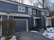 Side view of a lovely blue home with attached garage and winter landscaping at 7841 Harbour # 35, Indianapolis, IN 46240