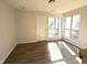 Sunlit living area featuring hardwood floors and sliding glass doors to deck at 7841 Harbour # 35, Indianapolis, IN 46240