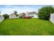 Expansive backyard featuring a large, green lawn, fire pit with benches, and shed at 8535 Blue Marlin Dr, Indianapolis, IN 46239