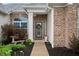 Beautiful front entrance highlighting the brick facade, a decorative wreath, and curated landscaping around the walkway at 8535 Blue Marlin Dr, Indianapolis, IN 46239