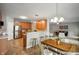 Open-concept kitchen and dining area with stainless steel appliances and breakfast bar with counter seating at 8535 Blue Marlin Dr, Indianapolis, IN 46239