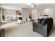 Open-concept living room featuring neutral paint, carpet, views to the kitchen, and comfortable seating arrangement at 8535 Blue Marlin Dr, Indianapolis, IN 46239