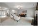 Bright living room with carpet flooring, neutral paint, a ceiling fan and an open view into the foyer at 8535 Blue Marlin Dr, Indianapolis, IN 46239