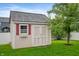 Backyard shed with red trim, double doors, and a window box at 8535 Blue Marlin Dr, Indianapolis, IN 46239