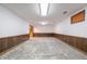 Unfinished basement with wood paneling, concrete floor, and stairs at 877 Revere Ct, Greenwood, IN 46142
