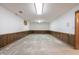 Unfinished basement area with wood paneling and concrete floor at 877 Revere Ct, Greenwood, IN 46142