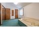 Bathroom with a large jacuzzi tub and mirrored closet doors at 877 Revere Ct, Greenwood, IN 46142
