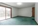 Spacious bedroom with balcony access and green carpeting at 877 Revere Ct, Greenwood, IN 46142