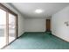 Bright bedroom featuring a sliding door to deck and green carpet at 877 Revere Ct, Greenwood, IN 46142