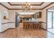 Dining room with hardwood floors, chandelier, and kitchen access at 877 Revere Ct, Greenwood, IN 46142