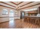 Dining room with hardwood floors, chandelier, and kitchen access at 877 Revere Ct, Greenwood, IN 46142