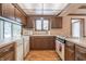 L-shaped kitchen with wooden cabinets and hardwood floors at 877 Revere Ct, Greenwood, IN 46142