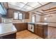 Kitchen with an island, wooden cabinets, and hardwood floors at 877 Revere Ct, Greenwood, IN 46142