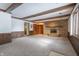Living room boasts a stone fireplace and wood-paneled walls at 877 Revere Ct, Greenwood, IN 46142