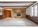 Living room with a stone fireplace, built-in shelves, and wood beams at 877 Revere Ct, Greenwood, IN 46142