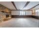 Living room features a stone fireplace and wood beam ceiling at 877 Revere Ct, Greenwood, IN 46142