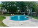 Relaxing kidney-shaped pool with surrounding lawn at 877 Revere Ct, Greenwood, IN 46142
