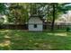 Large backyard with a charming shed nestled amongst mature trees at 877 Revere Ct, Greenwood, IN 46142