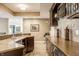 Basement bar area with stone countertops, stainless steel appliances, and tile flooring at 9399 Irishmans Run Ln, Zionsville, IN 46077