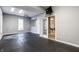 Spacious gray basement featuring rubber floor, a ceiling fan, and abundant natural light through large windows at 9399 Irishmans Run Ln, Zionsville, IN 46077