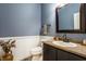 Stylish half bath with decorative wainscoting, granite countertop, and modern fixtures at 9399 Irishmans Run Ln, Zionsville, IN 46077
