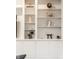Detailed view of custom built-in shelving showcasing decorative items and elegant design at 9399 Irishmans Run Ln, Zionsville, IN 46077