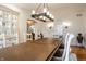 Spacious dining room with wood floors, decorative lighting, and an open archway at 9399 Irishmans Run Ln, Zionsville, IN 46077
