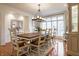 Elegant dining room features hardwood floors, large windows, and a stylish chandelier at 9399 Irishmans Run Ln, Zionsville, IN 46077