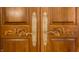 Close-up of the ornate, double wood doors with decorative hardware at 9399 Irishmans Run Ln, Zionsville, IN 46077