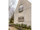 Close-up of a well-maintained brick home with decorative window features and professional landscaping at 9399 Irishmans Run Ln, Zionsville, IN 46077