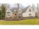 Charming two-story brick home featuring a manicured lawn and mature trees at 9399 Irishmans Run Ln, Zionsville, IN 46077