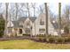 Charming two-story brick home featuring a manicured lawn and mature trees at 9399 Irishmans Run Ln, Zionsville, IN 46077